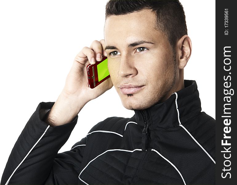 Studio shot of the young man in futuristic jacket with cell phone in right hand. Isolated on white background. Studio shot of the young man in futuristic jacket with cell phone in right hand. Isolated on white background