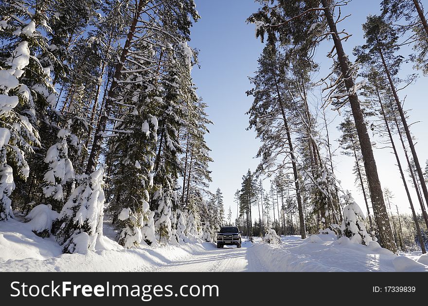 Large suv, driving on small snowy road through a swedish winter scenery. smaland, sweden. Large suv, driving on small snowy road through a swedish winter scenery. smaland, sweden