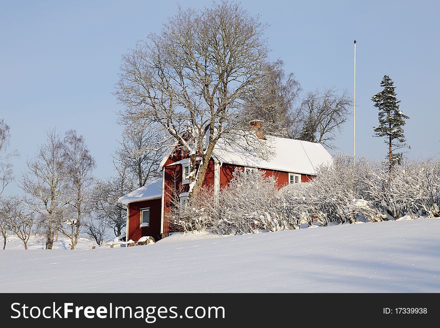 Red cottage and winter landscape