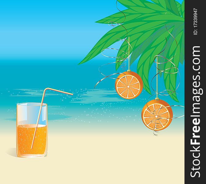 A glass of orange juice and oranges hanging on palm branches