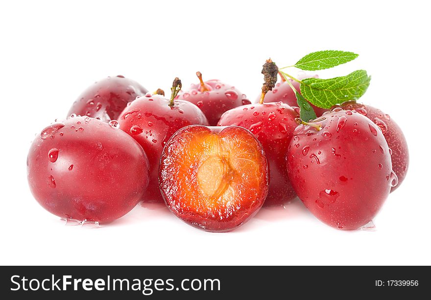 Wet ripe plums, isolated on white