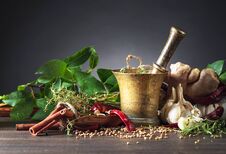 Mortar With Herbs And Spices On A Old Wooden Table Stock Photo