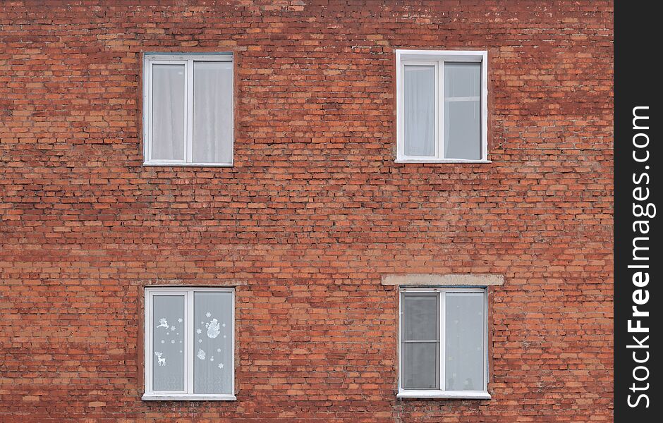 Brick wall with four Windows. Background, texture.