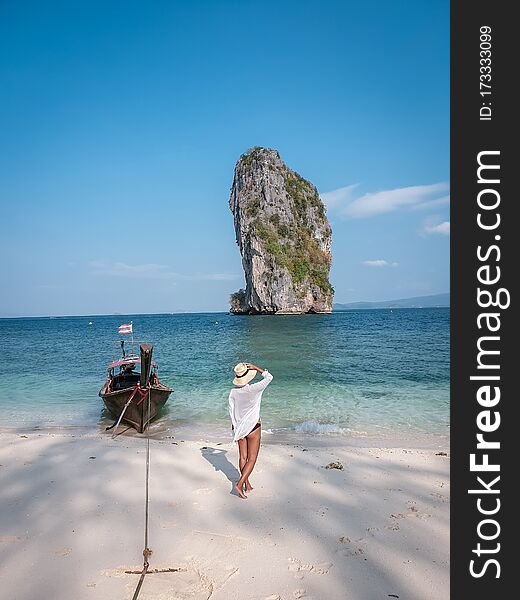 Koh Poda Krabi Thailand, white beach with crystal clear water in Krabi Thailand, woman with hat on the beach