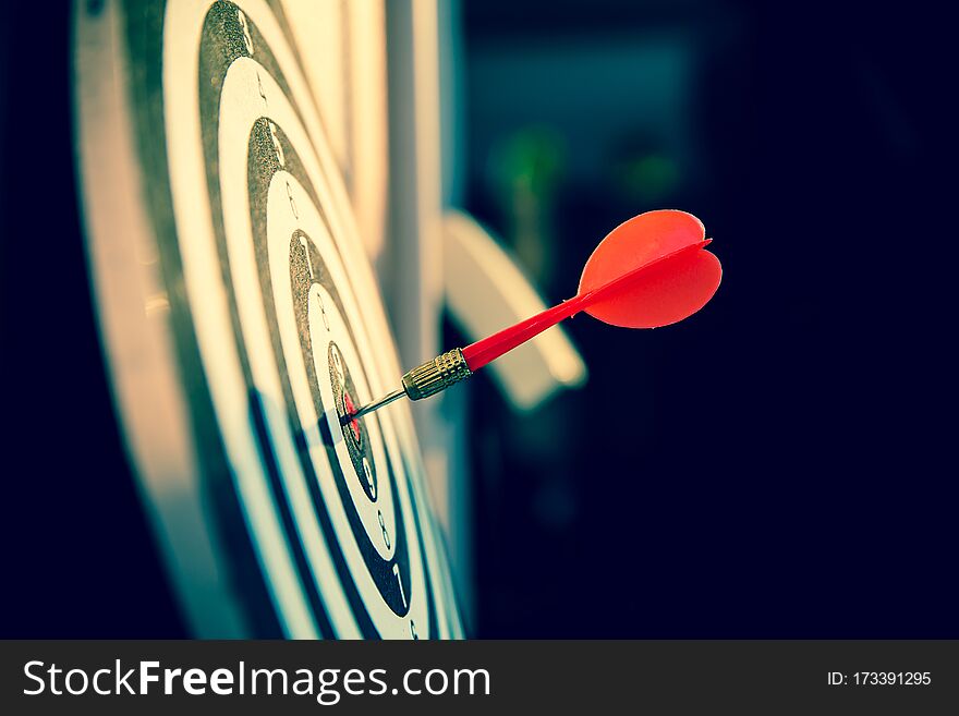 Close up a red color arrow in the center of Bullseye or bull`s-eye for business targeting