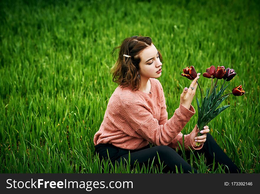 Romantic Girl With A Bouquet Of Flowers In The Spring Garden