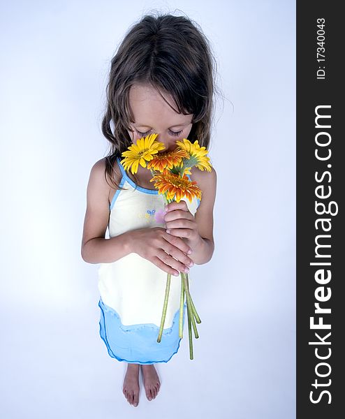 A little girl holding in her hand a beautiful flower. A little girl holding in her hand a beautiful flower