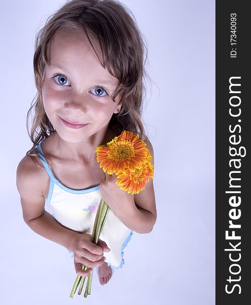 A little girl holding in her hand a beautiful flower. A little girl holding in her hand a beautiful flower