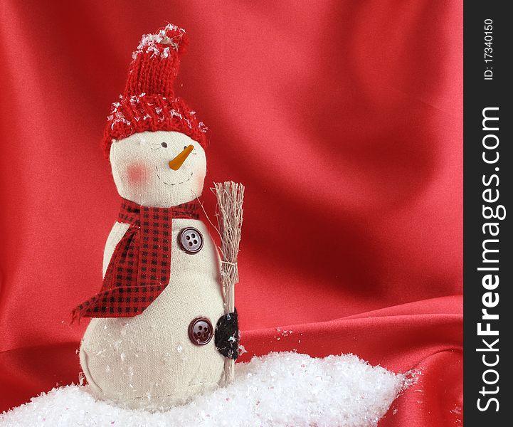Adorable vintage hand-made snowman standing in a drift of snow. Adorable vintage hand-made snowman standing in a drift of snow