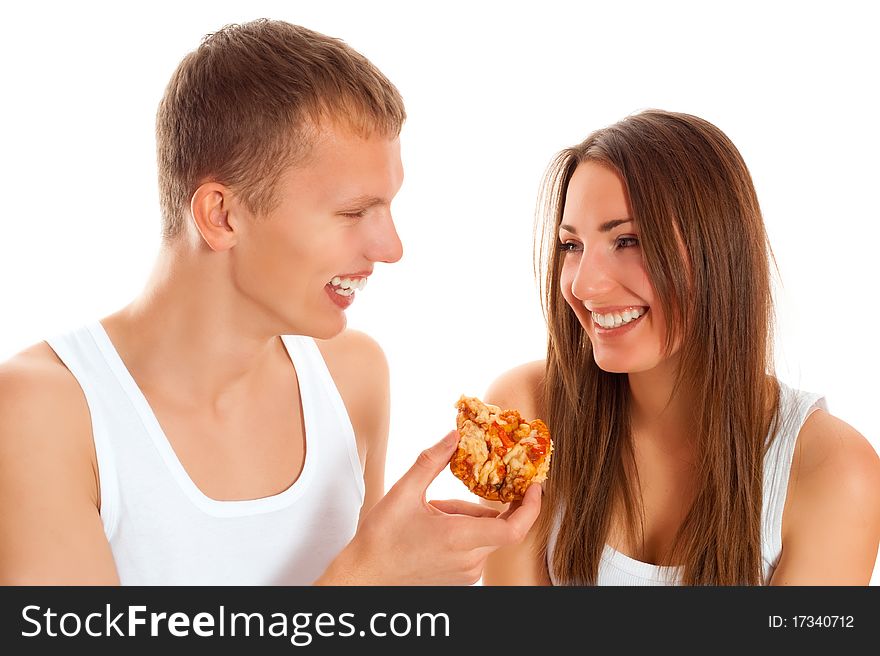 Beautiful couple eating pizza isolated over white