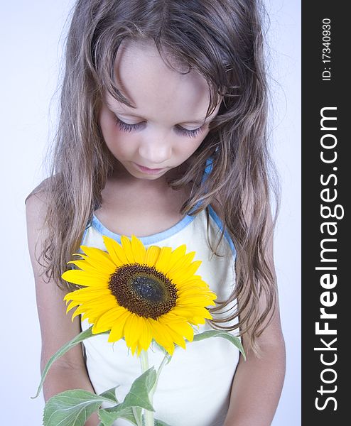 A little girl holding in her hand a beautiful flower