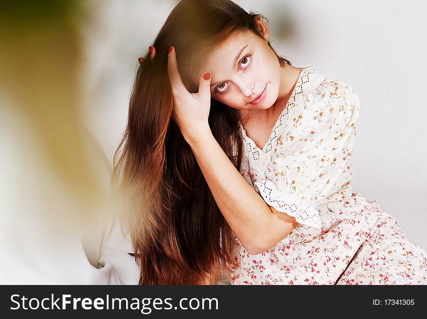 Beauty young woman with pretty hairs in light dress