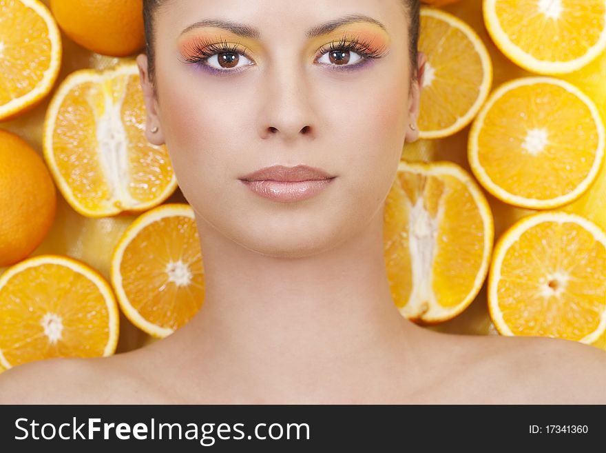 Young Beautiful Woman With Oranges