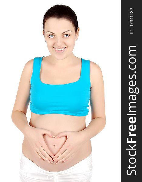 Happy young pregnant woman holding her belly heart shaped isolated on white