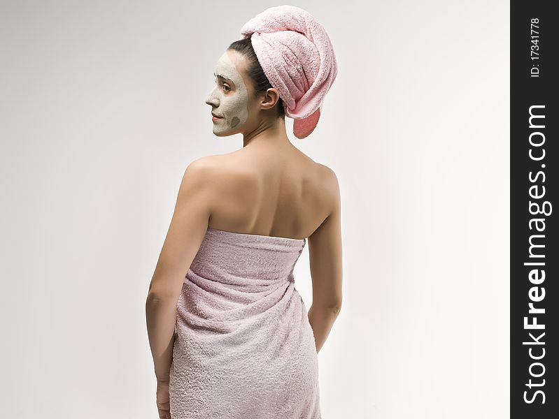 Woman with beauty mask wearing towels. Woman with beauty mask wearing towels