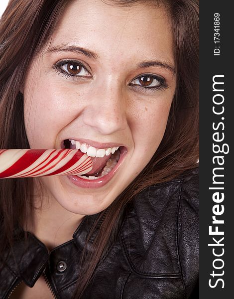 A close up of a woman eating a big round peppermint stick. A close up of a woman eating a big round peppermint stick.