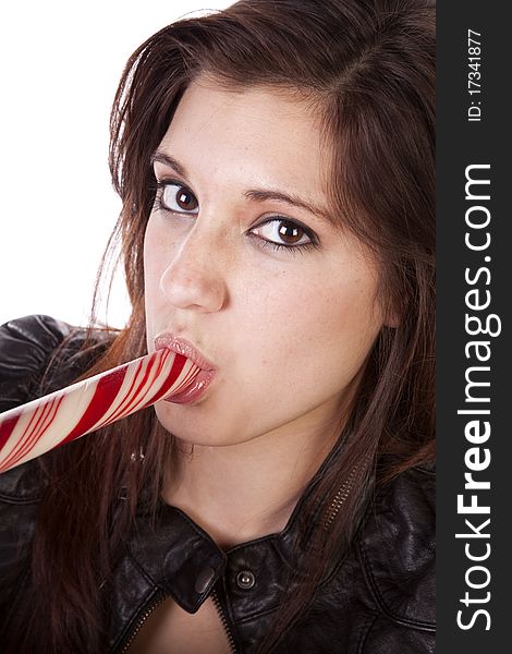 A close up of a woman eating a big round peppermint stick. A close up of a woman eating a big round peppermint stick.