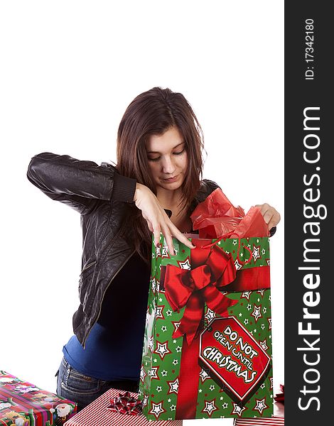 A woman taking a good look into her Christmas gift with a serious expression on her face. A woman taking a good look into her Christmas gift with a serious expression on her face.