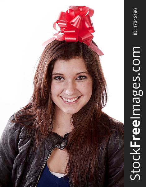 A woman wearing a red gift bow on her head with a big smile on her face. A woman wearing a red gift bow on her head with a big smile on her face.
