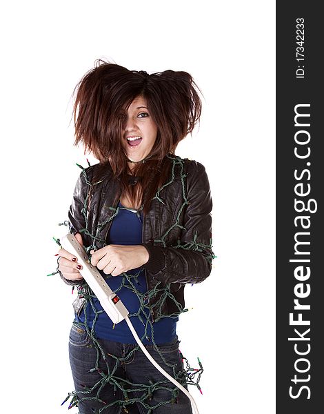 A woman all tied up in Christmas lights with a shocked expression on her face and her hair standing up on end. A woman all tied up in Christmas lights with a shocked expression on her face and her hair standing up on end.