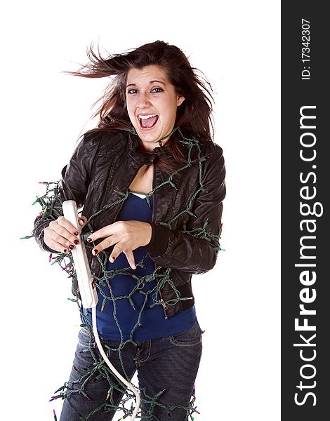 A woman all tied up in Christmas lights with a happy expression on her face and her hair standing up on end. A woman all tied up in Christmas lights with a happy expression on her face and her hair standing up on end.