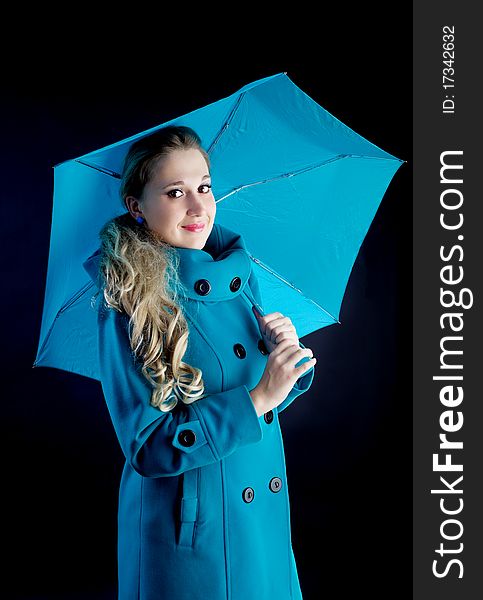 Young girl with blue umbrella