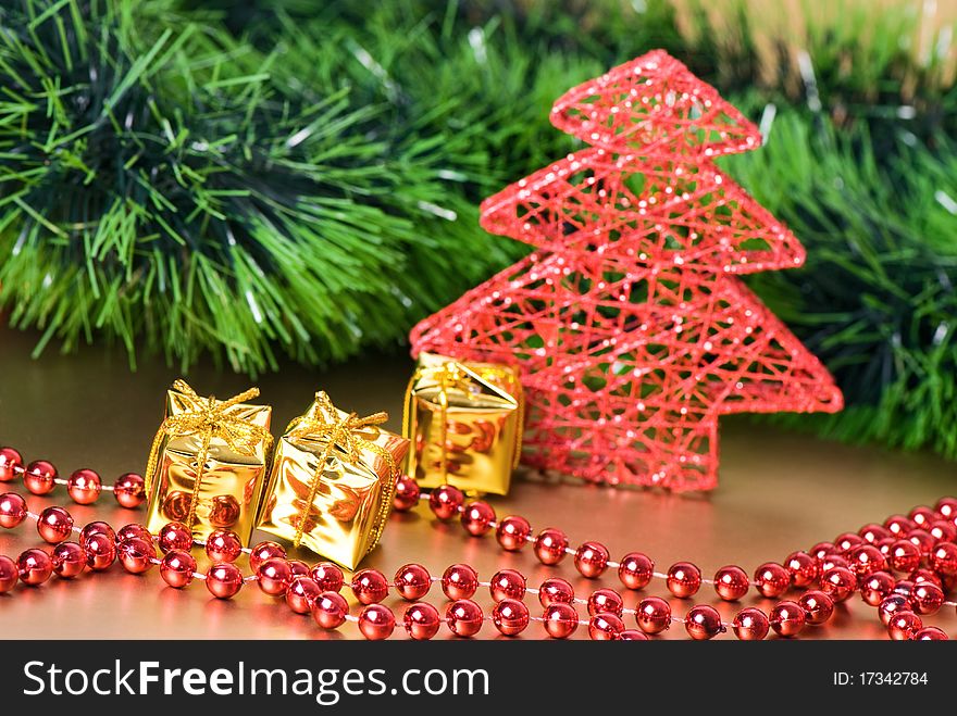 Christmas still life with golden gift boxes and red new year's tree