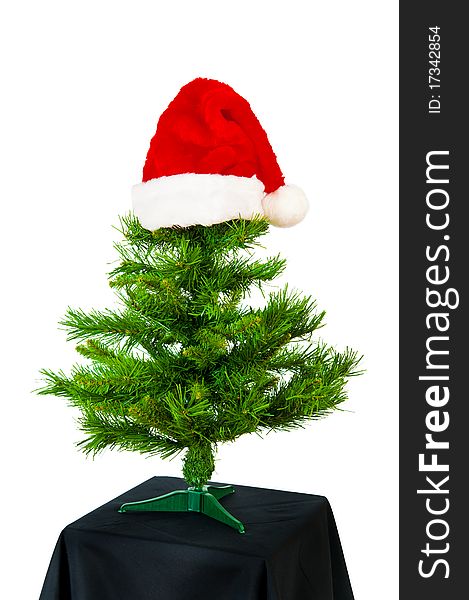 Xmas tree with red hat on white background. Xmas tree with red hat on white background