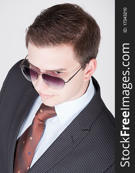 Studio portrait of a young businessman with sunglasses