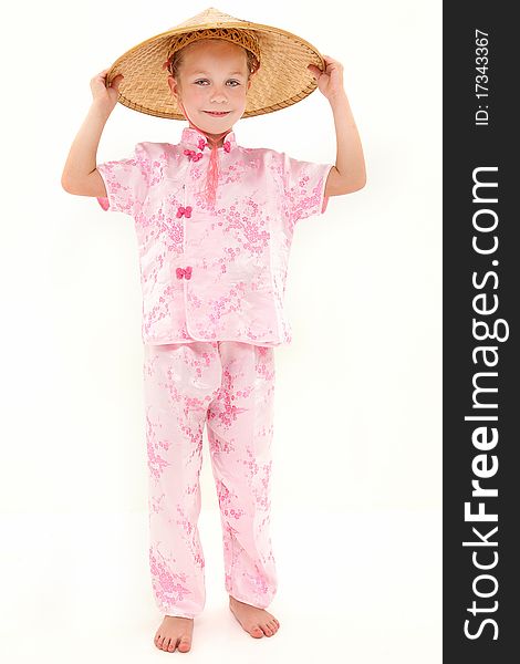 Adorable 6 year old blond american girl wearing bamboo hat and pink outfit. Adorable 6 year old blond american girl wearing bamboo hat and pink outfit.