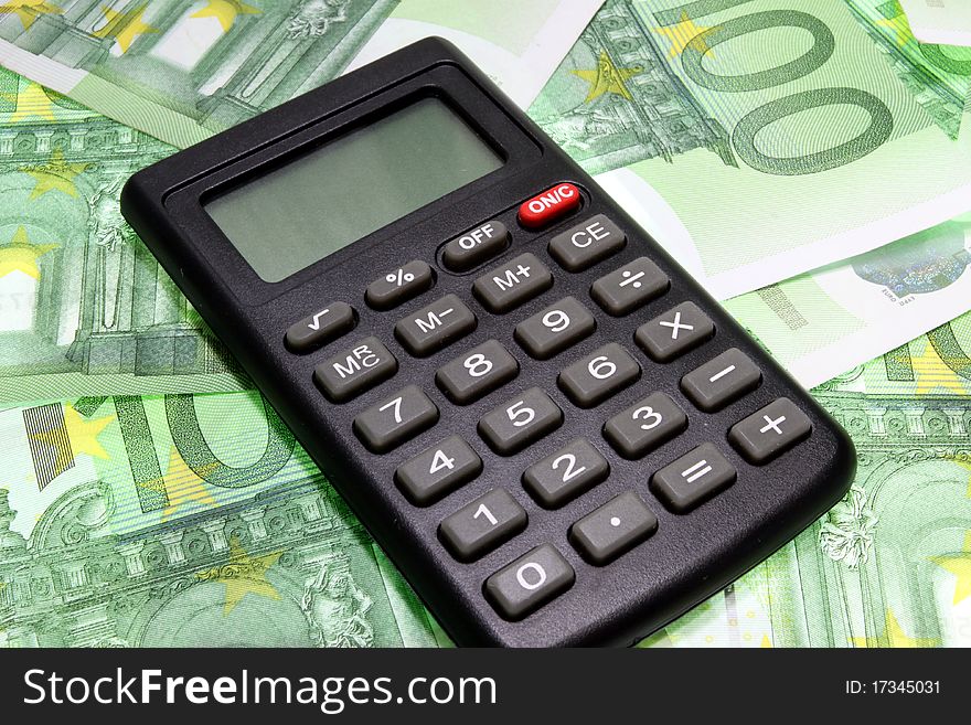 Black calculator standing on euros. Black calculator standing on euros