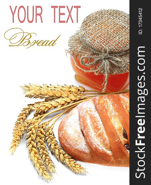 Wheat bread, honey and spikelets on a white background. Wheat bread, honey and spikelets on a white background