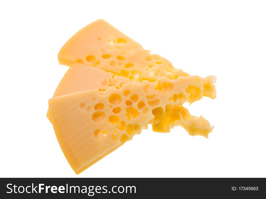 Some pieces of yellow cheese on a white background