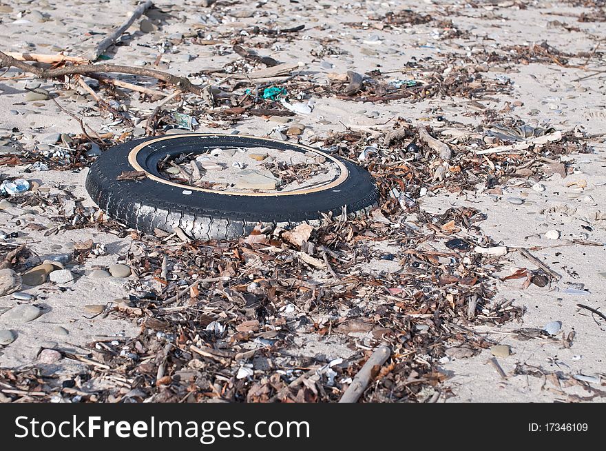 Tire And Other Litter On A Beach