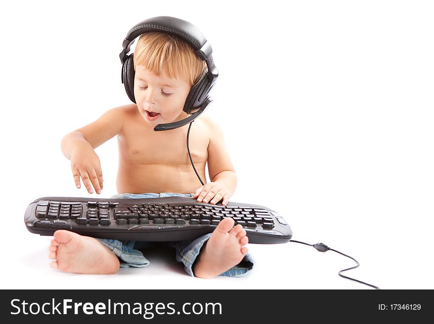 Little boy with headphones and keyboard. Little boy with headphones and keyboard