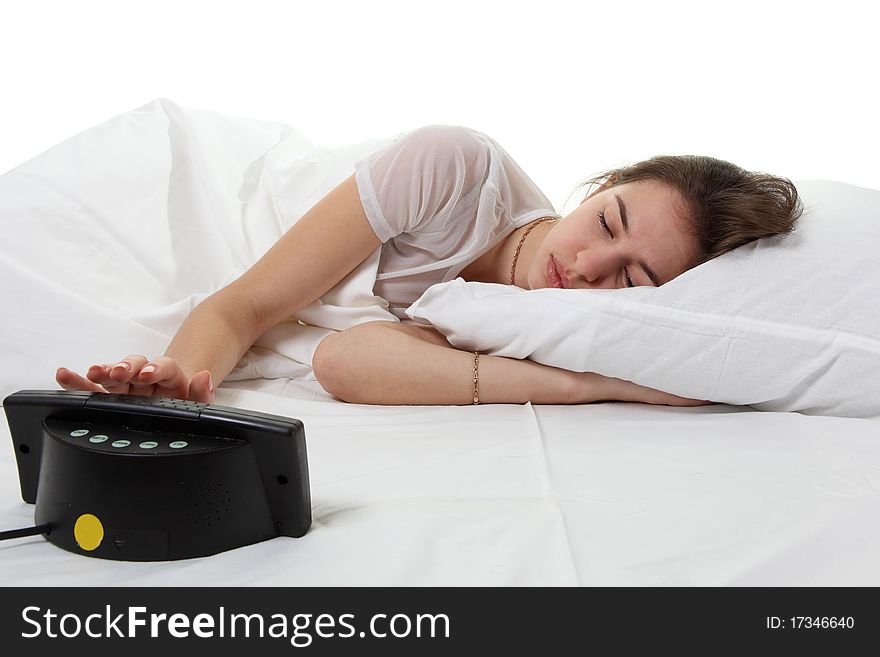 Young woman sit in a bed with alarm clock. Young woman sit in a bed with alarm clock