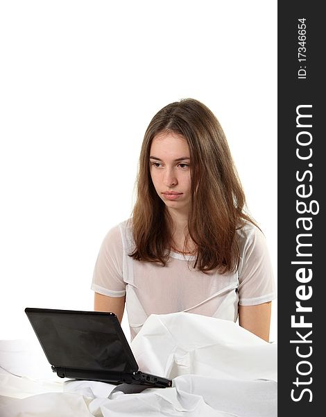 Young woman sit in a bed with notebook. Young woman sit in a bed with notebook