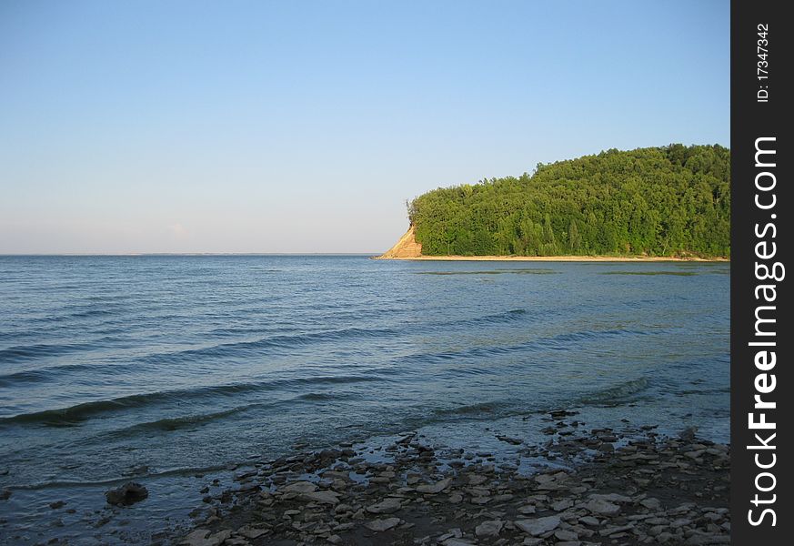 Abrupt river bank Volga covered with  thick forest