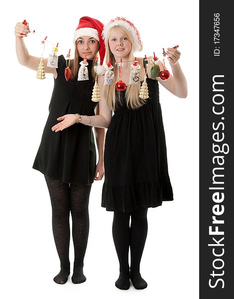 Two girls in the Santa hat and gifts on a white background