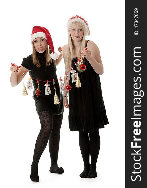 Two girls in the Santa hat and gifts on a white background