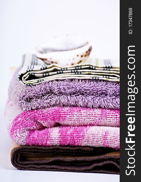 Closeup of colorful bath towels and sea shell