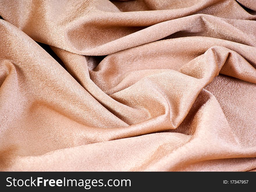 Golden luxury textile with folds. Golden luxury textile with folds