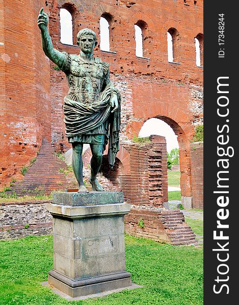 Caesar Augustus bronze statue in Turin front of a roman brick walls. Caesar Augustus bronze statue in Turin front of a roman brick walls