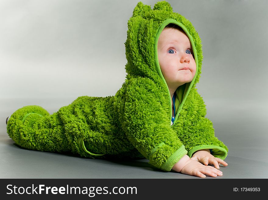 Sweet cute baby dressed in a frog suit. Sweet cute baby dressed in a frog suit