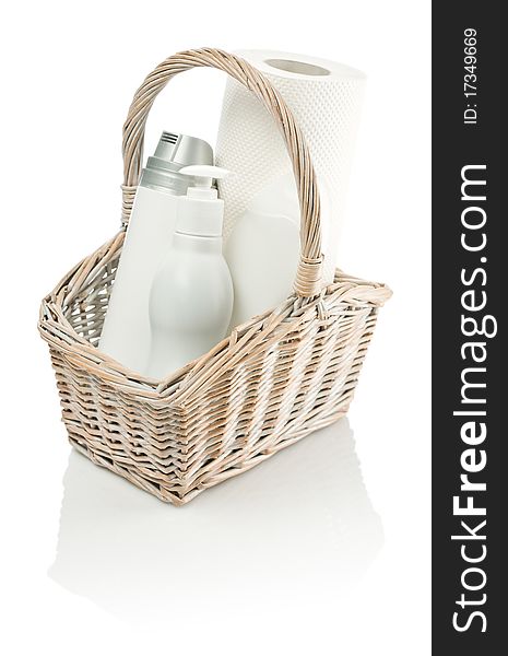 Basket with bottles and paper towel isolated on white