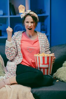Happy Beautiful Girl Face Watching Comedy Film In Home. Millennial Woman Sitting On Sofa And Watching TV. Concept Of Stock Image