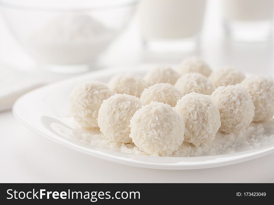 White small cakes sprinkled with coconut shavings. White small cakes sprinkled with coconut shavings.