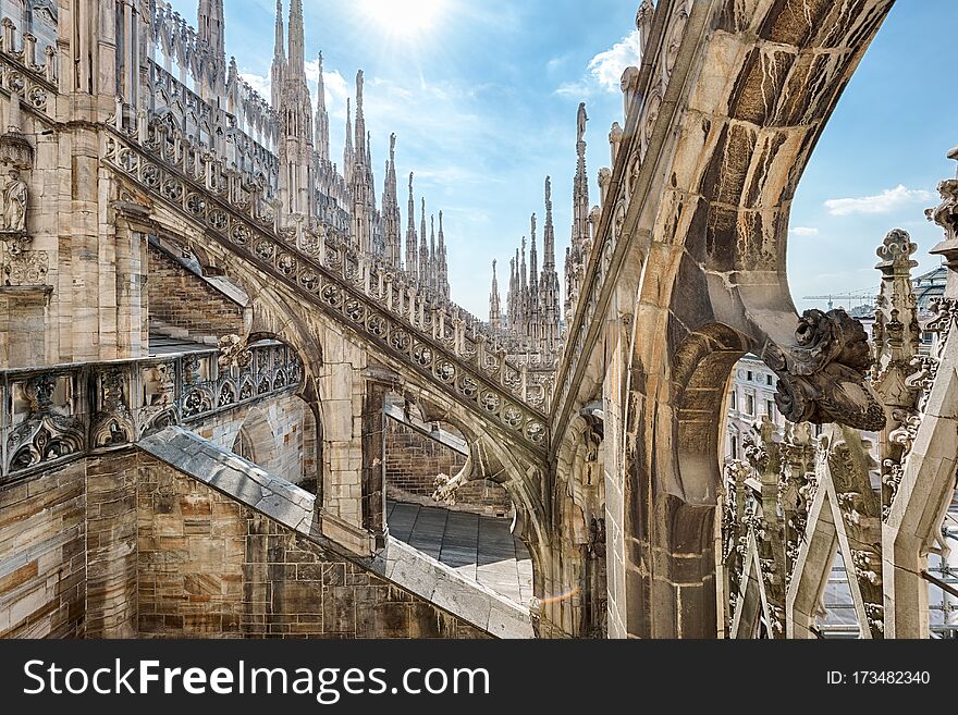 Milan Cathedral roof, Italy, Europe. Milan Cathedral or Duomo di Milano is top landmark of Milan city. Beautiful Gothic architecture of Milan against blue sky. Detail of luxury rooftop decorations