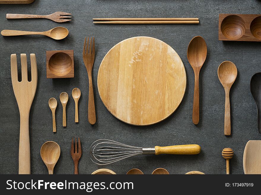 Kitchen utensils for cooking on the wooden black table, food prepare concept