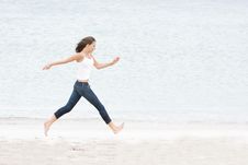 Woman Running On Sand Beach Stock Photo